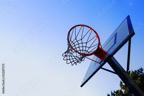 Basket in an outdoor playing field with clear sky © alphaspirit