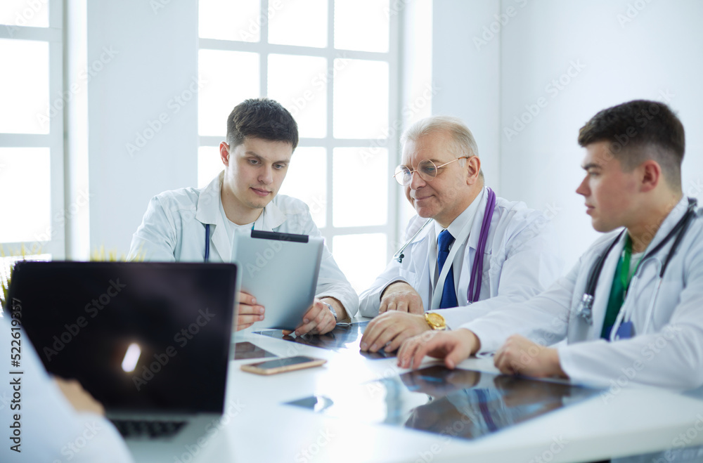 Medical team sitting and discussing at table Medical team sitting and discussing at table