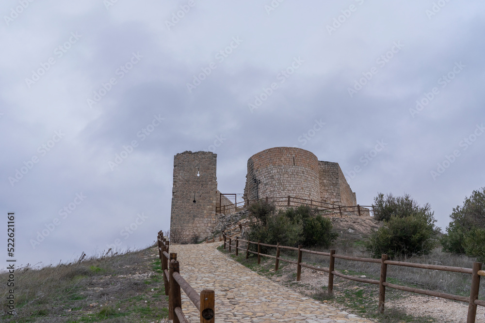 Spectacular castle of Jadraque on the mountain on a cloudy and windy day.