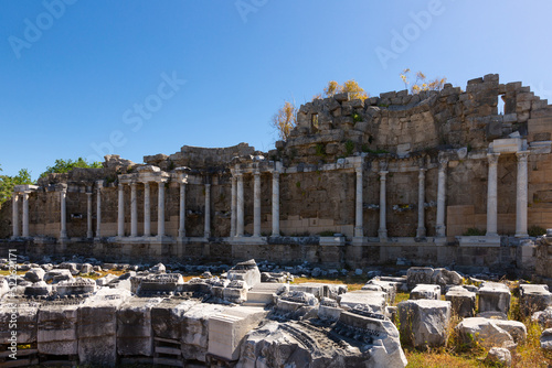 Partially restored architectural elements of Nymphaeum building in ancient city of Side on sunny spring day. Turkish historical and cultural monument