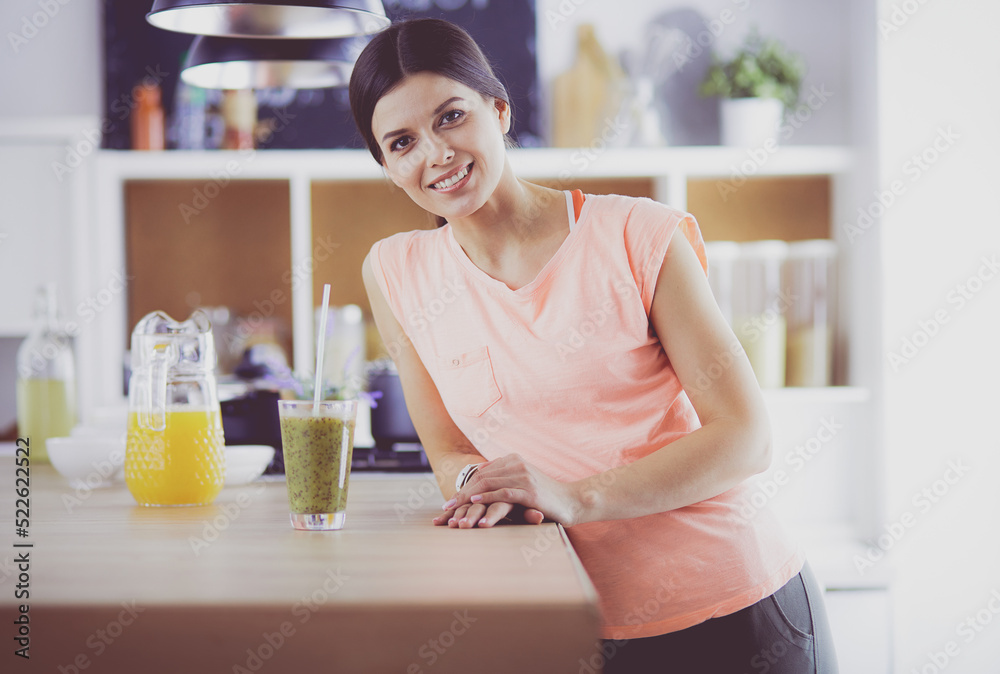 Young woman sitting a table in the kitchen Young woman sitting a table in the kitchen
