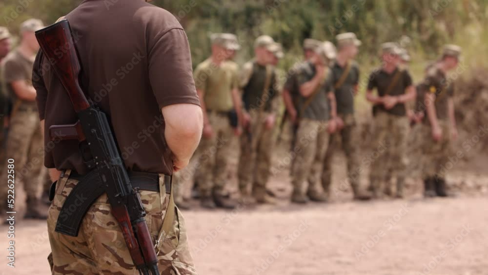 Thousands of soldiers stand at the checkpoint, wearing uniforms behind their backs and carrying Kalashnikov assault rifles, close-up of row of Ukrainian soldiers armed with Kalashnikov assault rifles Thousands of soldiers stand at the checkpoint, wearing uniforms behind their backs and carrying Kalashnikov assault rifles, close-up of row of Ukrainian soldiers armed with Kalashnikov assault rifles