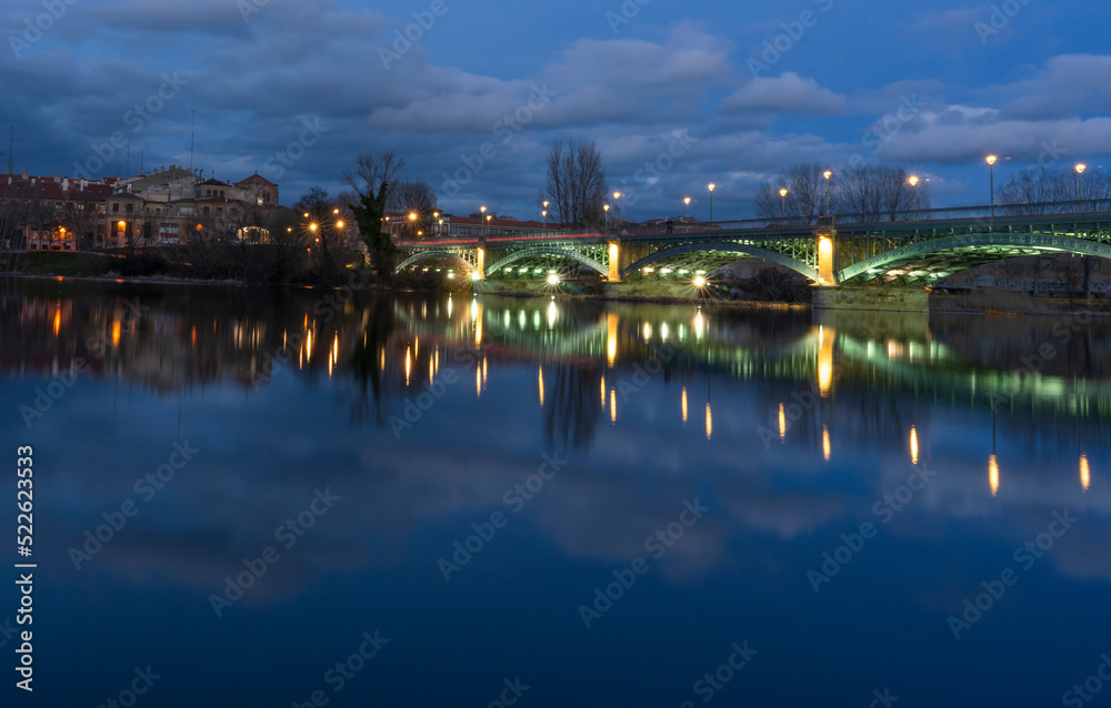 reflections of a night bridge in the city of Salamanca (Spain)