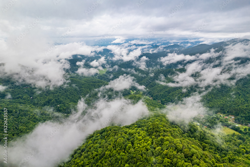 Panorama of Mountains. Over the clouds. Green forest. Scenic aerial view. Great Smoky Mountains North Carolina. Thick fog. White clouds. Green hill. Hiking tourism. Good for travel agency or posters.