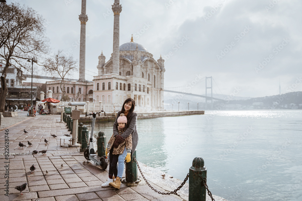 mother and daughter portrait in front of ortakoy mosque in istanbul turkiye