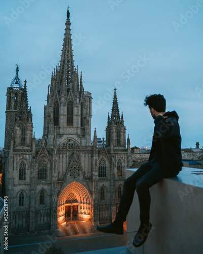Fotografie Young millennial adult on a rooftop in a risky situation daredevil looking at  B