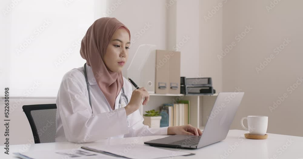 Islam arab GP video call talk share on telemedicine telehealth teleconsult clinic platform app at office desk. Young medic health care worker work for asia people tele consult on online remote visit. Islam arab GP video call talk share on telemedicine telehealth teleconsult clinic platform app at office desk. Young medic health care worker work for asia people tele consult on online remote visit.