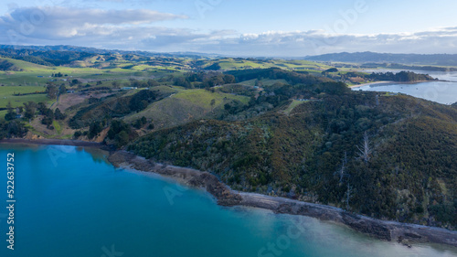 Aerial View of Waitawa Regional Park, Beach, Pier, Deck Green Trees and Cliff in New Zealand - Auckland Area