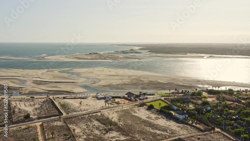 Low tide water canals and small Macapa village on Brazilian seashore in sunlight photo