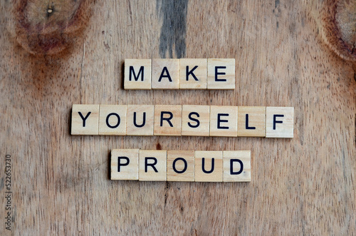 Photography make yourself proud text on wooden square, motivation quotes