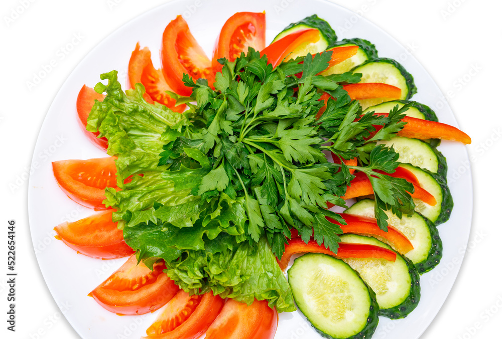 Sliced tomatoes, cucumbers, red pepper and garnished with parsley and lettuce. Fresh Vegetables Plate. Isolate Sliced tomatoes, cucumbers, red pepper and garnished with parsley and lettuce. Fresh Vegetables Plate. Isolate