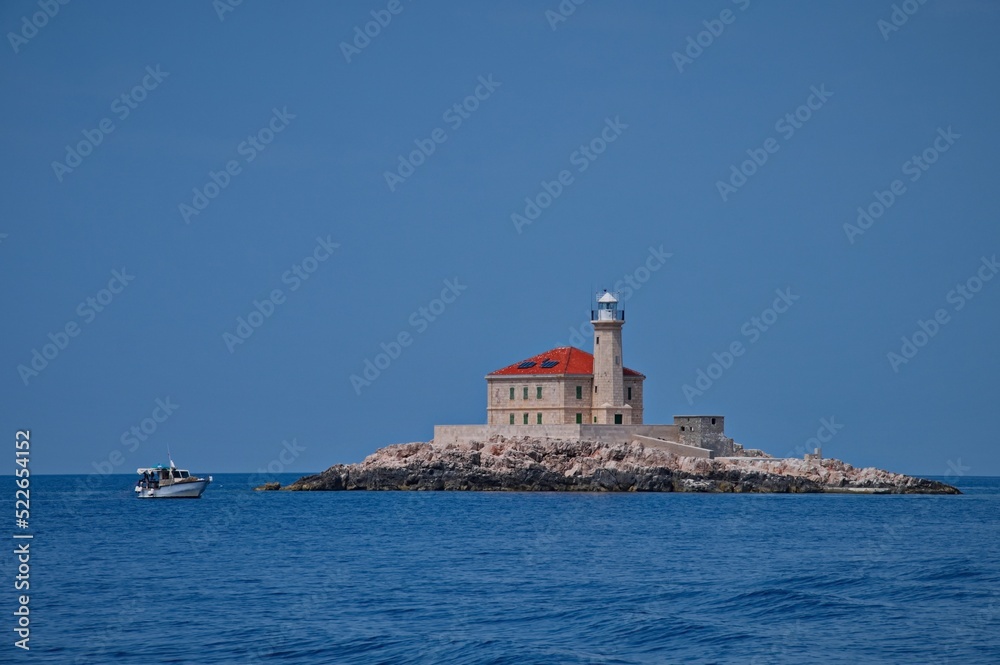 Lighthouse in clear blue Adriatic sea