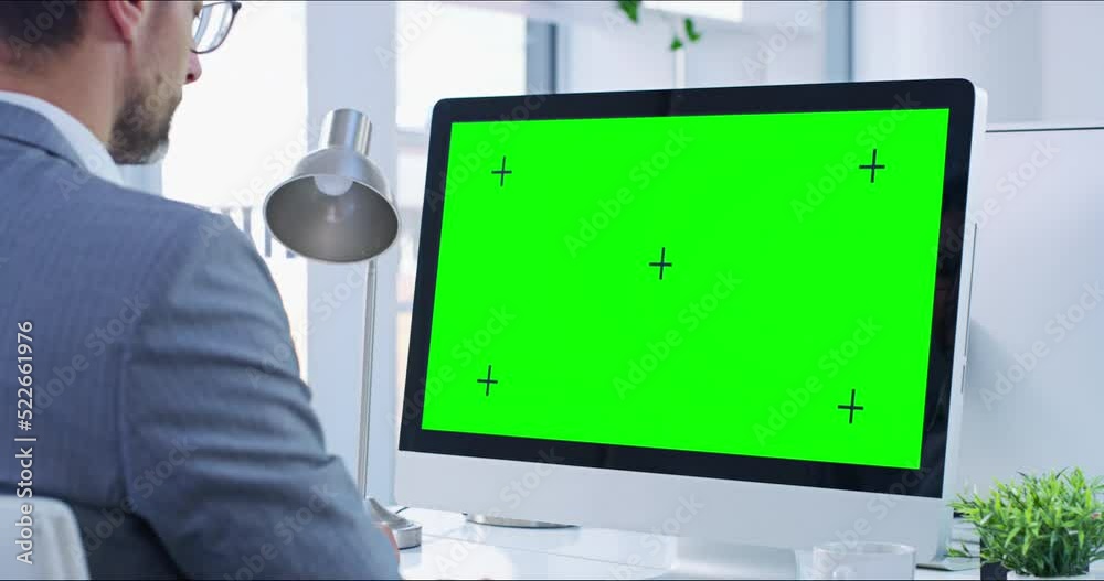 Greens creen, copyspace and chromakey on a computer screen with tracking markers and a business man working. Copy space for advertising, marketing and promotion with a corporate professional typing