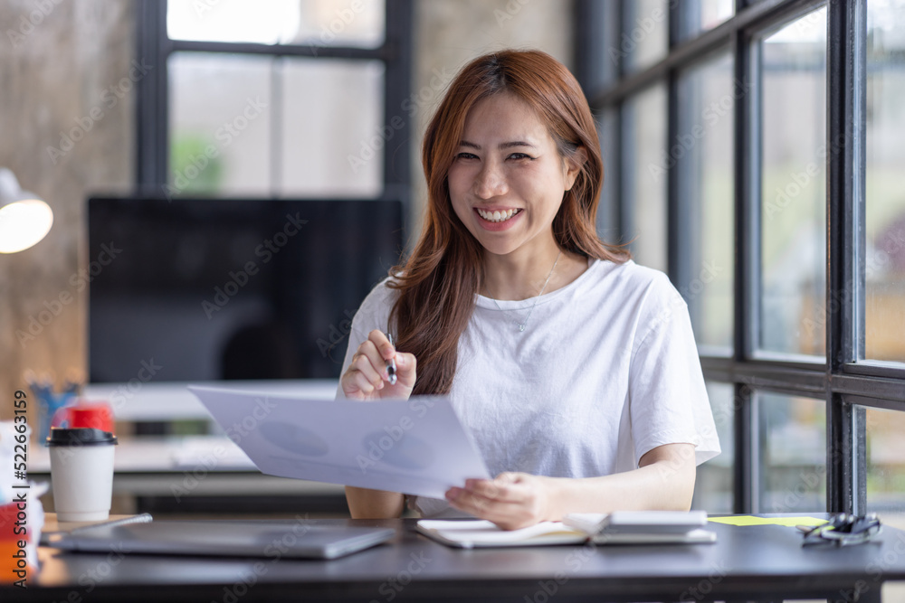 Business Asian woman freelancer is working her job on computer laptop from home office Doing accounting analysis report real estate investment data, Financial and tax systems concept. Business Asian woman freelancer is working her job on computer laptop from home office Doing accounting analysis report real estate investment data, Financial and tax systems concept.