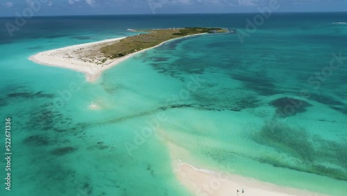 Aerial approach on caribbean island Cayo de Agua without peculiar isthmus, long and narrow strip of land joins island photo