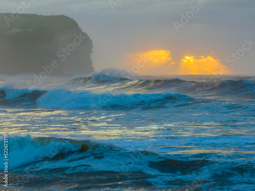 Sunrise at the seaside with large and powerful sets © Merrillie
