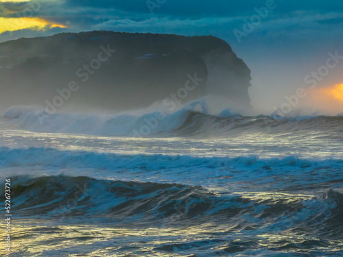 Fototapeta Naklejka Na Ścianę i Meble -  Sunrise at the seaside with large and powerful sets