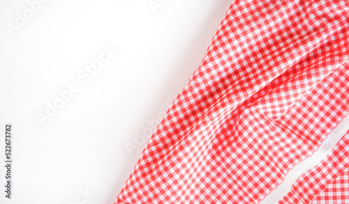 Crumple pink plaid fabric or classic tablecloth in the corner of white background with copy space