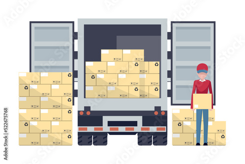Worker loading a box from a pallet with stacked boxes in warehouse to a refrigerator truck. Industrial storage and distribution of products
