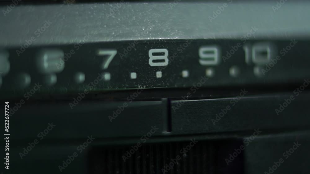 Placing Analog Selector on Position 8, Volume Control on Vintage Audio Amplifier Macro Close Up Shot Placing Analog Selector on Position 8, Volume Control on Vintage Audio Amplifier Macro Close Up Shot