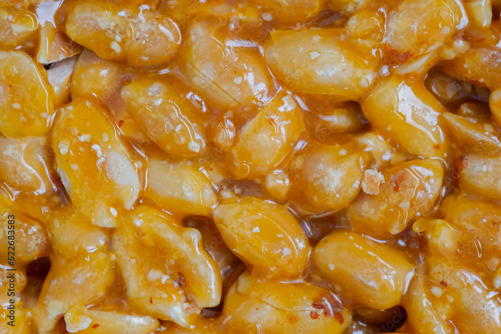 Top view: Gozinaki - caramelized nuts fried in honey - orange granola peanut bar - macro, close up. Traditional Georgian cuisine, oriental sweet, gastronomy and food concept Top view: Gozinaki - caramelized nuts fried in honey - orange granola peanut bar - macro, close up. Traditional Georgian cuisine, oriental sweet, gastronomy and food concept