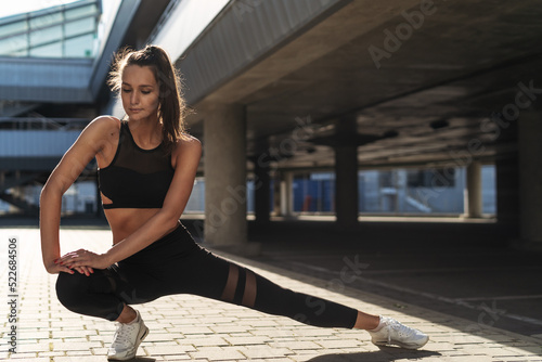 Woman doing stretching exercise in the city