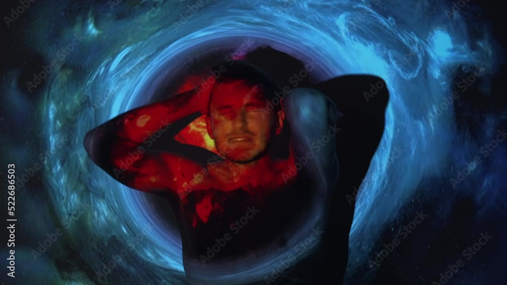 Panic attack. Anxiety crisis. Emotional burnout. Silhouette of disturbed frustrated man screaming clutching head in red fire flame blue smoke cloud swirl projector light on dark.