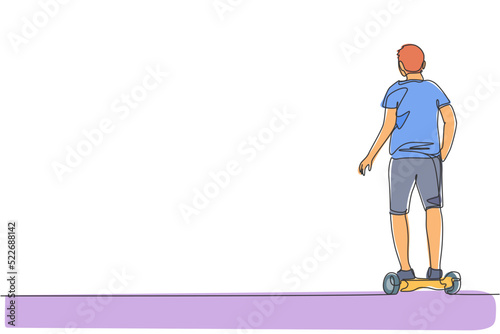 One continuous line drawing young happy man stand and ride hoverboard at outdoor park. Green transportation. Future urban lifestyle concept. Dynamic single line draw design vector graphic illustration