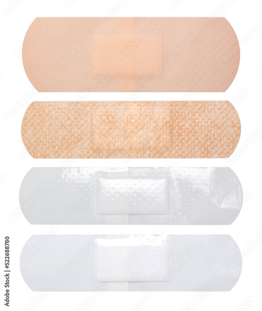 A set of four different band-aids on white background. A set of four different band-aids on white background.