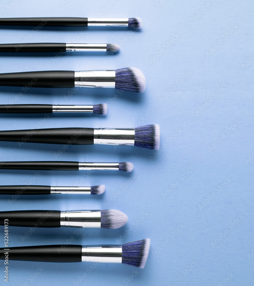 Creative concept beauty fashion photo of cosmetic product make up brushes kit on blue background. Creative concept beauty fashion photo of cosmetic product make up brushes kit on blue background.