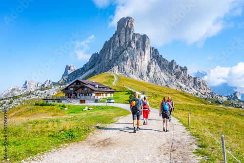 Group of hikers walks towards mountains