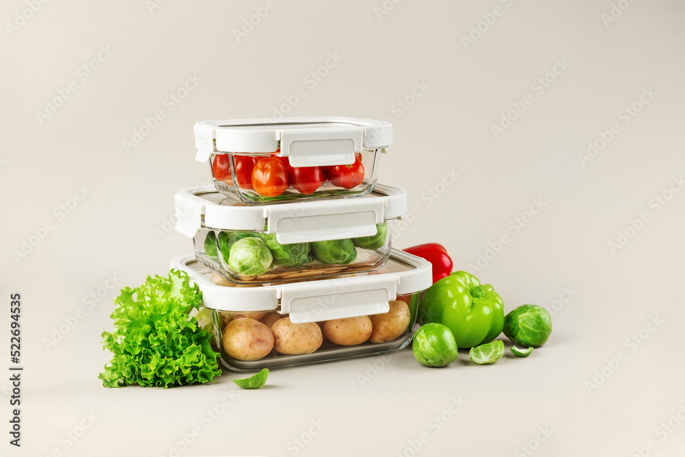 Glass boxes with fresh raw vegetables. Vegetables and fruits in glass containers. Food storage concept