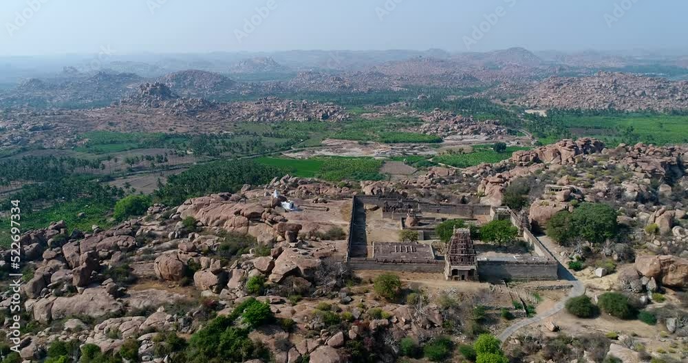 Aerial shot of rocky landscape with bouldery hills, hindu temple on top Aerial shot of rocky landscape with bouldery hills, hindu temple on top