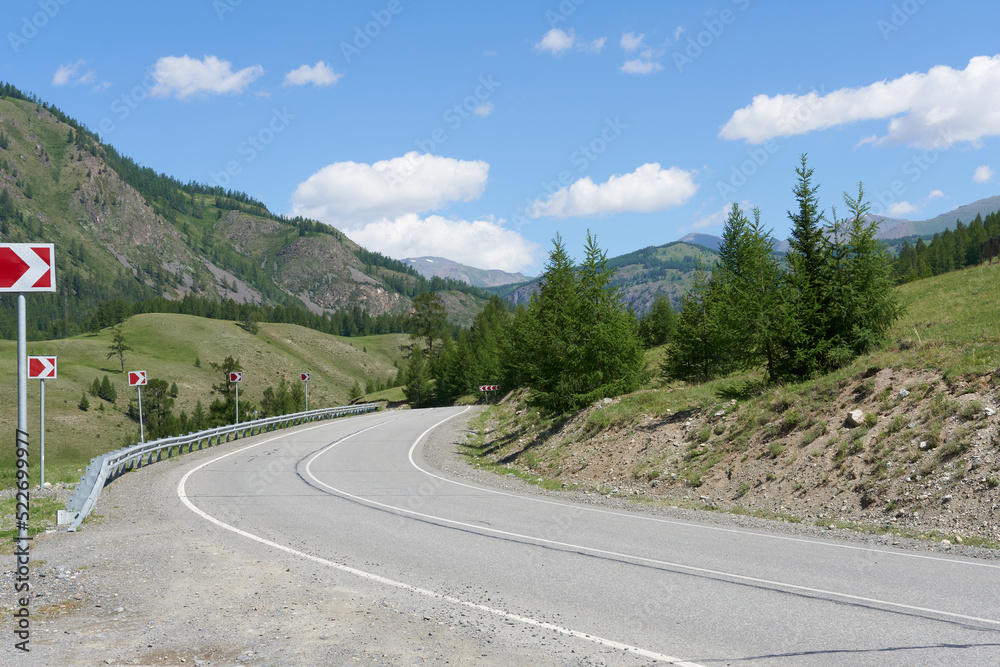 The road close-up, a sharp right turn in the mountains. Picturesque place, beautiful photo wallpaper. 