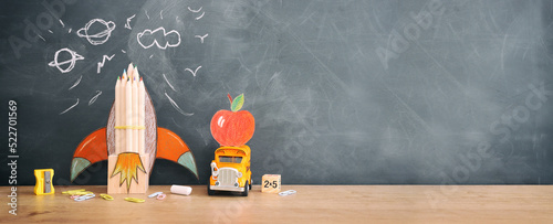 education. Back to school concept over wooden table and blackboard background