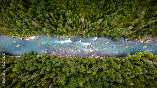 Group of friends spending time on the river enjoying kayaking and rafting together