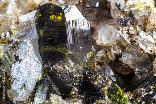 Ultra macro picture of small quartz points with one dark green epidote spike on matrix