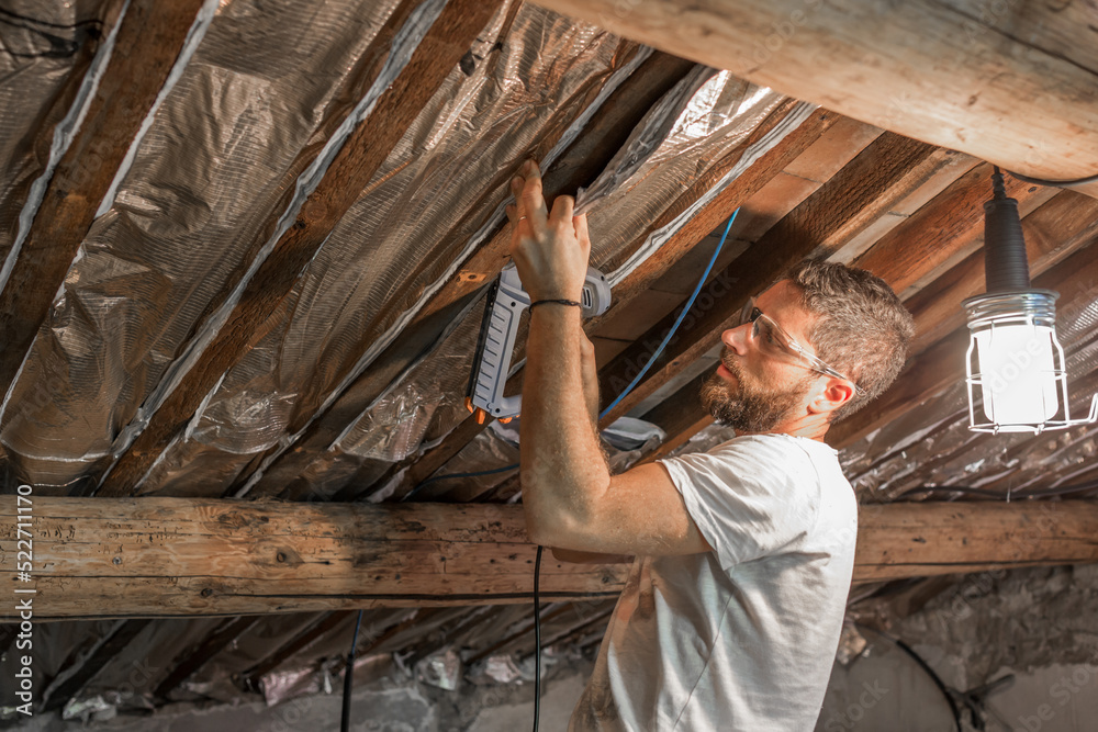 Worker with glasses and protective mask isolating the ceiling Worker with glasses and protective mask isolating the ceiling