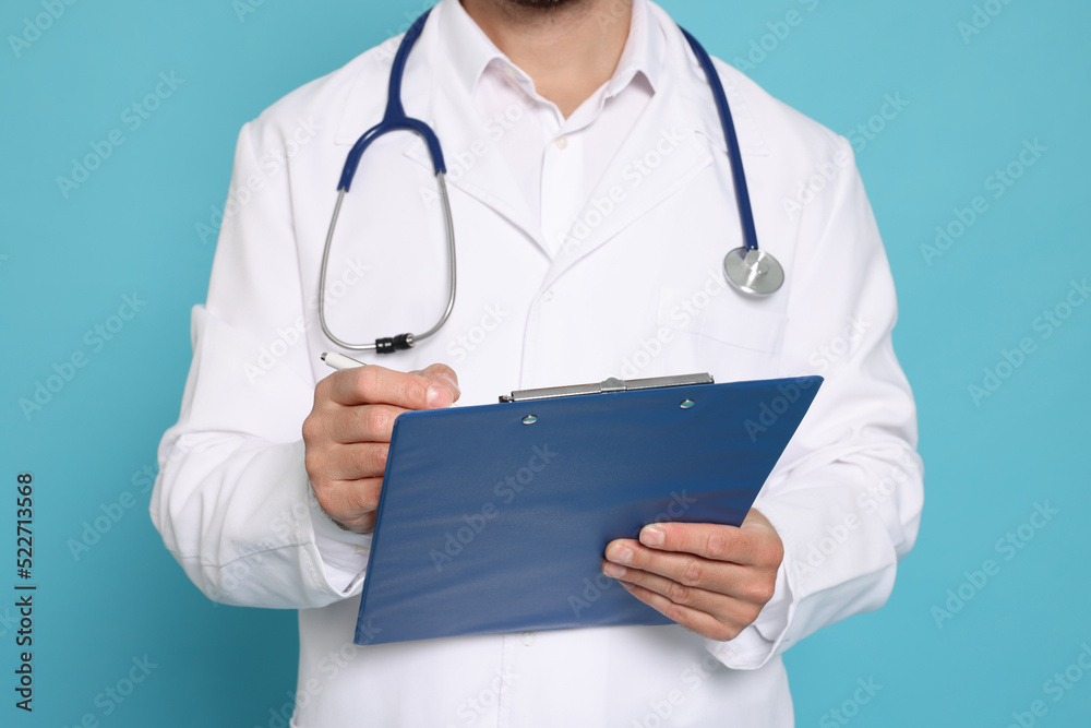 Doctor with stethoscope and clipboard on light blue background, closeup Doctor with stethoscope and clipboard on light blue background, closeup