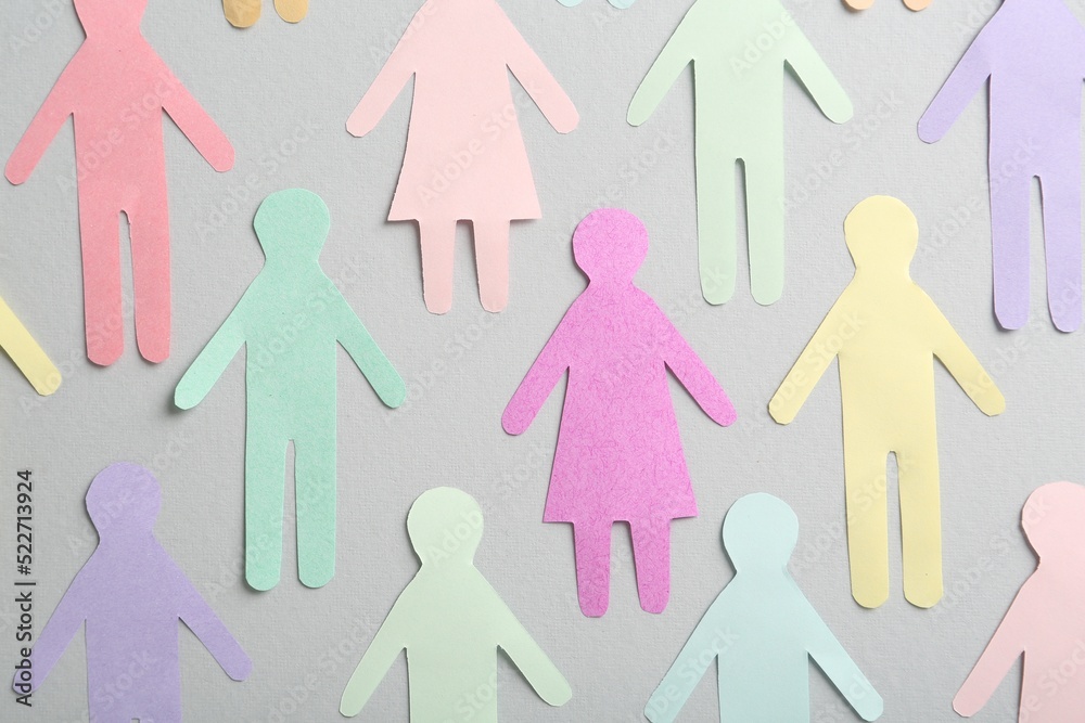 Many different paper human figures on grey background, flat lay. Diversity and inclusion concept Many different paper human figures on grey background, flat lay. Diversity and inclusion concept