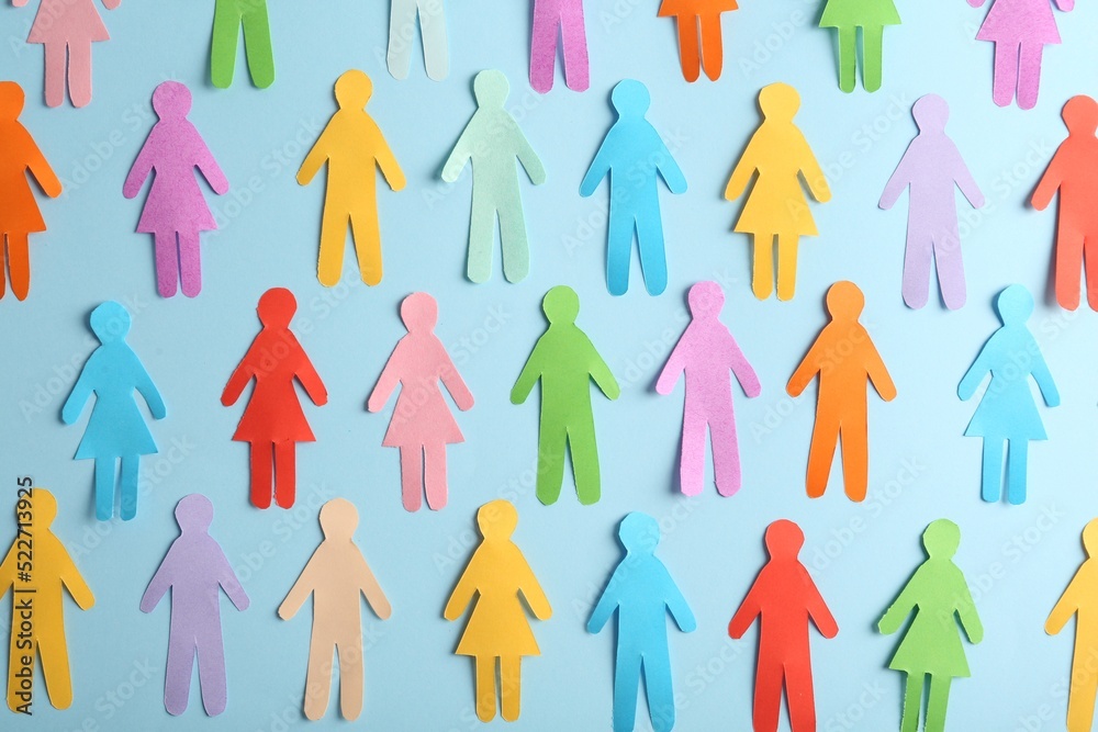 Many different paper human figures on light blue background, flat lay. Diversity and inclusion concept Many different paper human figures on light blue background, flat lay. Diversity and inclusion concept