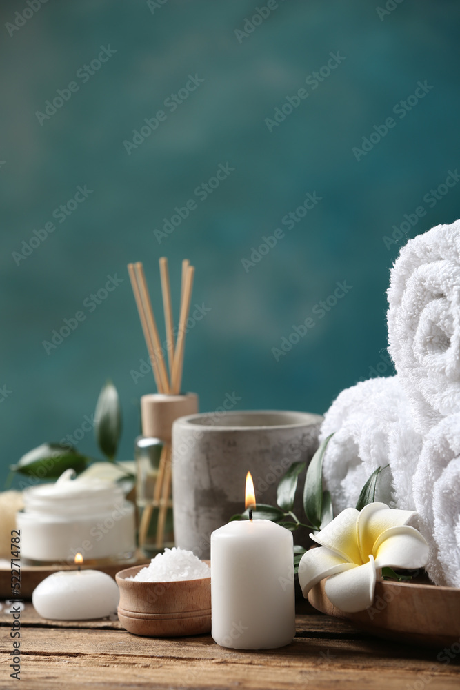 Beautiful spa composition with plumeria flower on wooden table. Space for text
