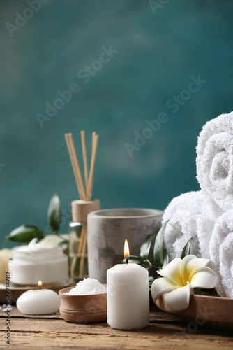 Beautiful spa composition with plumeria flower on wooden table. Space for text