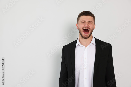 Aggressive young man shouting on white background, space for text