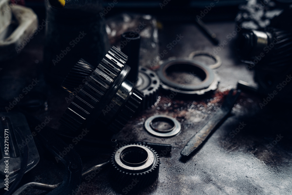 Mechanical parts of car in car repair shop. dark tone.