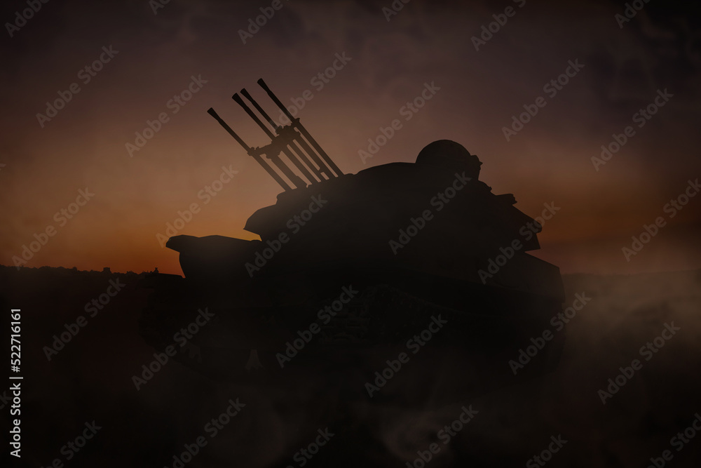 Fototapeta premium Silhouette of armored fighting vehicle on battlefield in night