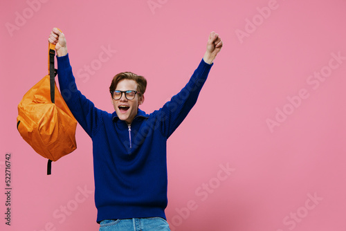 happy, joyful student in glasses rejoices by raising his hands up
