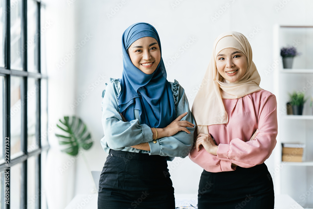 Portrait of muslim business woman wearing hijab, Business concept of signing the joint contract. Beautiful muslim business lady in hijab sitting together.
