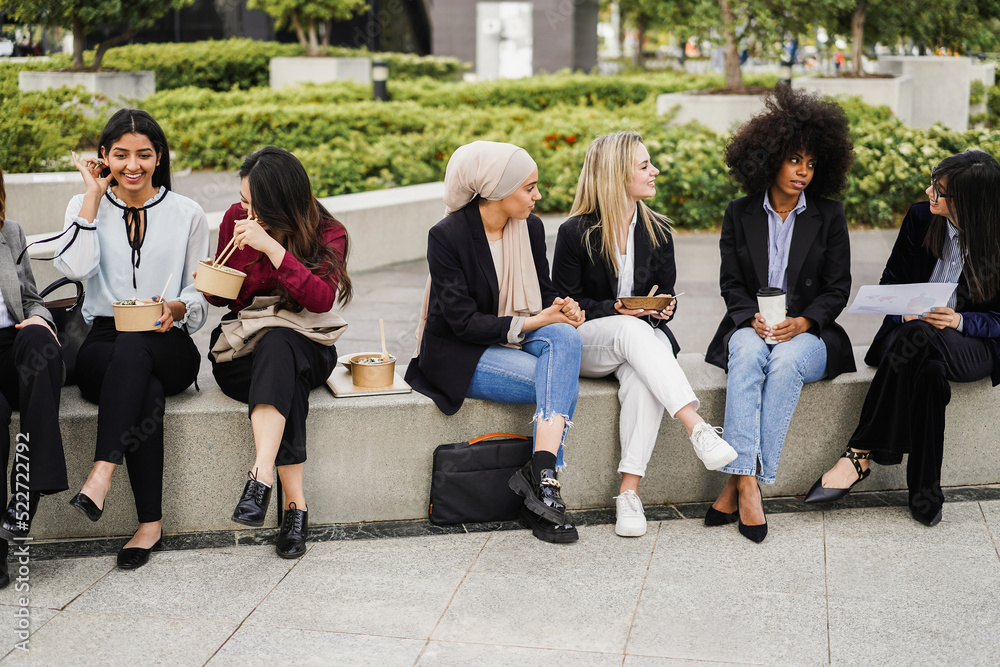 Fototapeta premium Multiethnic business women doing lunch break outdoor from office building - Main focus on indian girl face