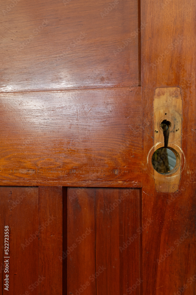 Fototapeta premium A vintage rimu wooden door has had its door furniture removed while it is being renovated